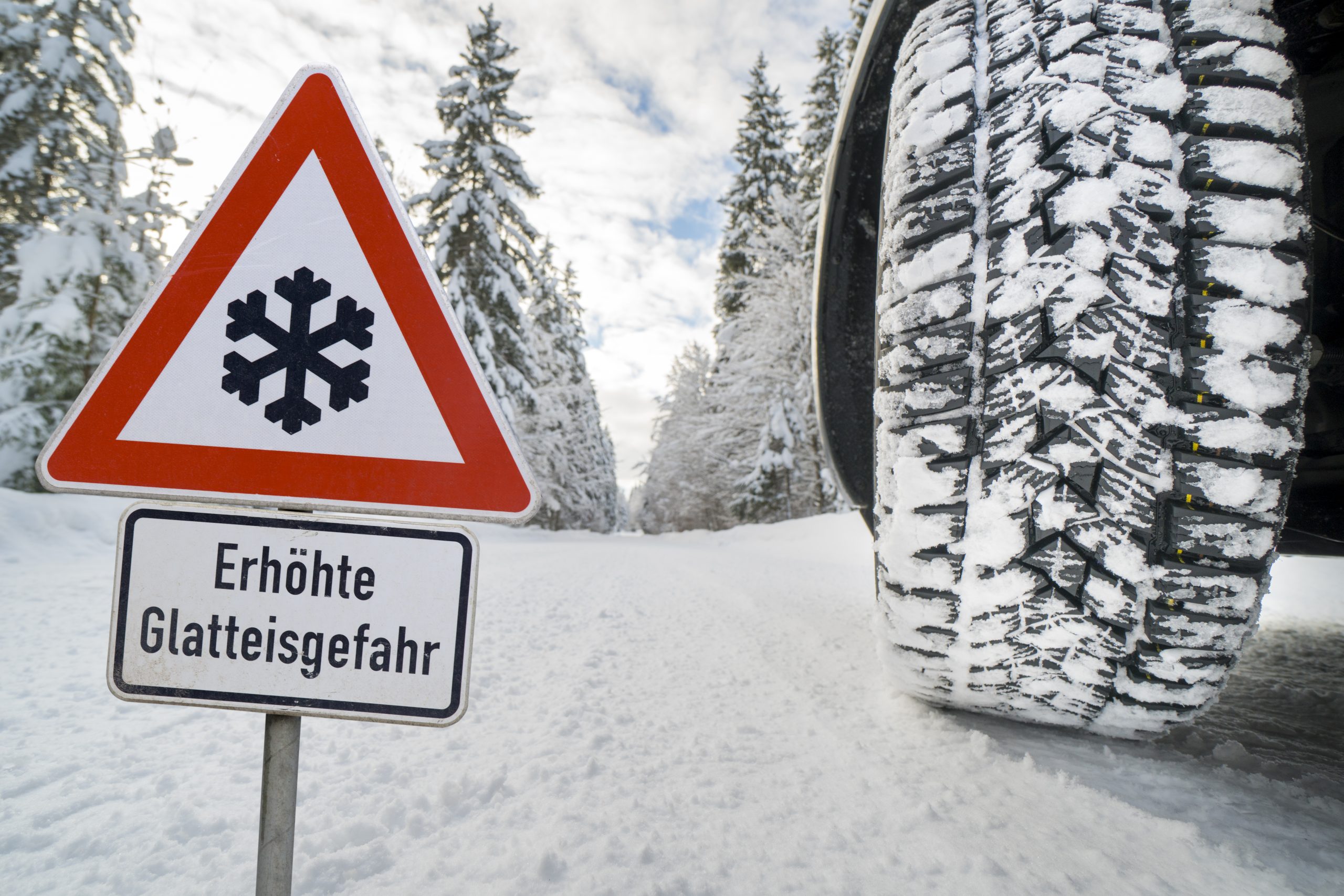 road sign warns ice snow winter scaled