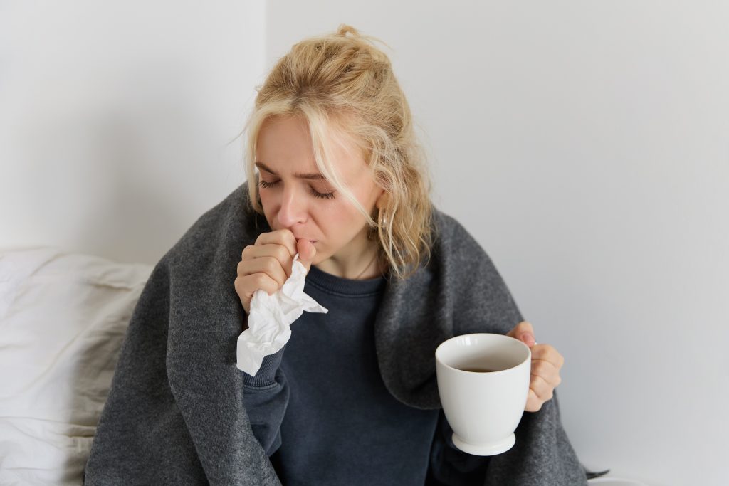 concept flu quarantine close up portrait young woman feeling sick caught cold sneezing